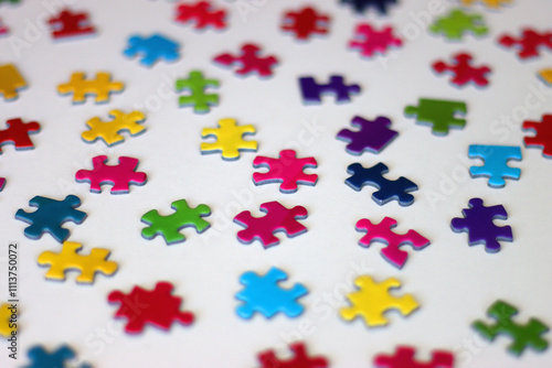 Colorful jigsaw puzzle pieces on white background. Selective focus.