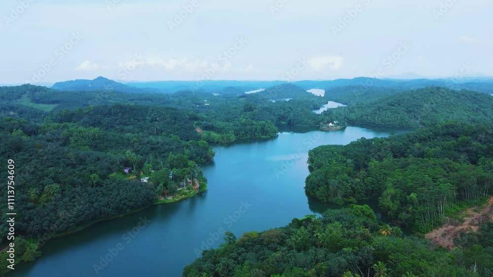 Gravity dam , Areal view of a Beautiful reservoir dam in Kerala, India, Morning view of Neyyar dam, Mountains and small green islands are seen in this video Gravity dam , Areal view of a Beautiful reservoir dam in Kerala, India, Morning view of Neyyar dam, Mountains and small green islands are seen in this video