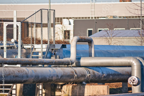 pipelines against the backdrop of factory buildings, blue sky in the background photo