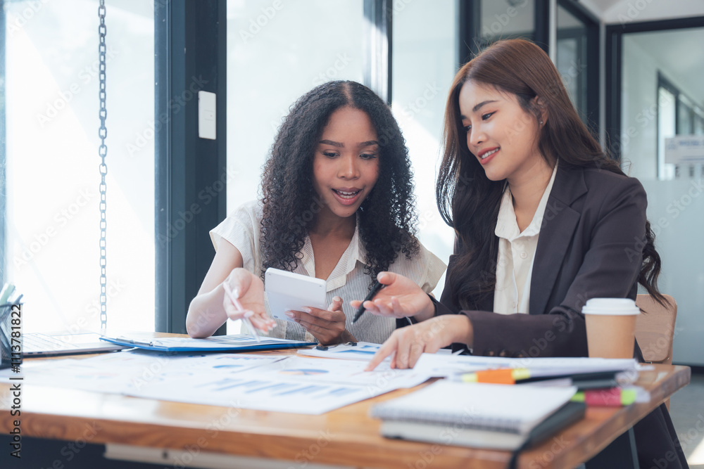 Collaborative Businesswomen Reviewing Documents Collaborative Businesswomen Reviewing Documents