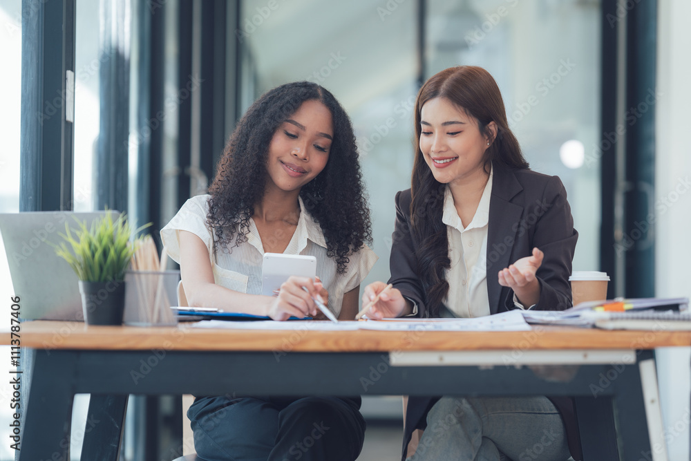 Collaborative Success: Two diverse businesswomen engage in a productive discussion, their expressions reflecting focus and enthusiasm. The image captures the essence of effective teamwork. Collaborative Success: Two diverse businesswomen engage in a productive discussion, their expressions reflecting focus and enthusiasm. The image captures the essence of effective teamwork.