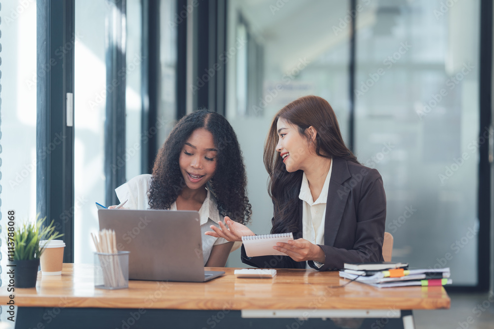 Successful Collaboration: Two Businesswomen Reviewing Documents Successful Collaboration: Two Businesswomen Reviewing Documents
