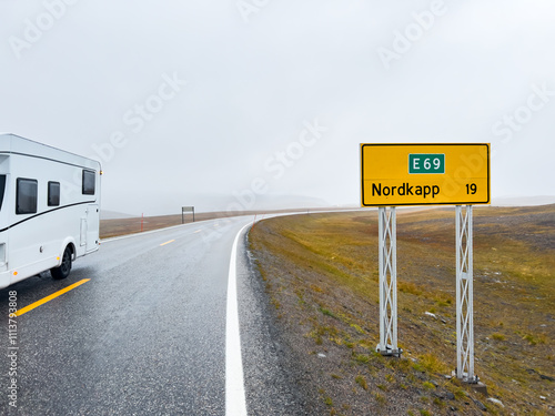 Camper van traveling on the e69 road to nordkapp, norway, on a rainy and foggy day photo