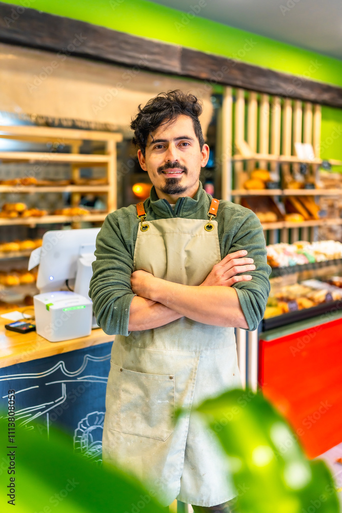 Fototapeta premium Artisan baker standing proud in the shop of new business
