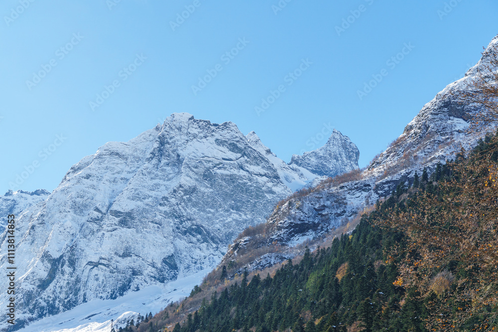 Picturesque landscape in Dombay with amazing snow-capped peaks and majestic blue slopes of North Caucasus Mountains Picturesque landscape in Dombay with amazing snow-capped peaks and majestic blue slopes of North Caucasus Mountains