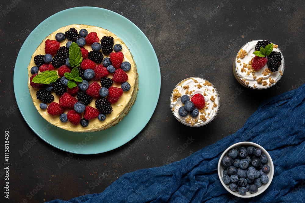 Homemade cake with fresh berries and sweet desserts on dark background. Homemade cake with fresh berries and sweet desserts on dark background.