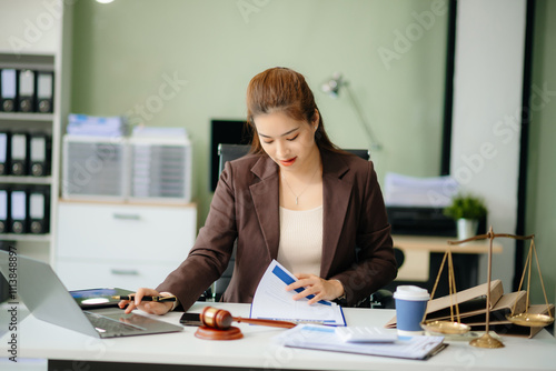 Asian Female judge in a courtroom on white table and Counselor or Male lawyer working in office.