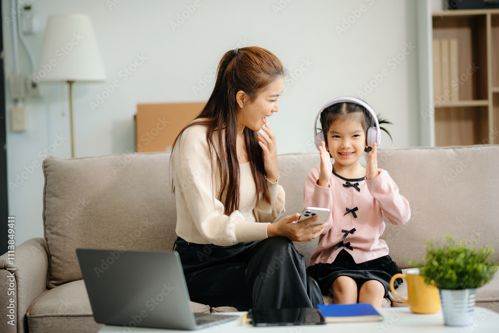 A caring mother and young daughter share a bonding moment doing homework at home. A caring mother and young daughter share a bonding moment doing homework at home.