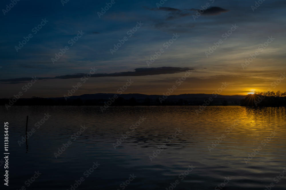 Vysatov pond with sunset color light in autumn sunny evening Vysatov pond with sunset color light in autumn sunny evening