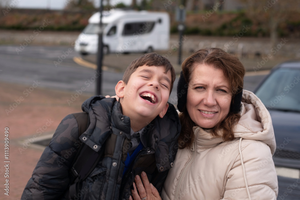 A mother and her son share a joyful moment outdoors in winter attire. The scene captures warmth and happiness , emphasizing the strong bond of family and laughter. They talk and laugh A mother and her son share a joyful moment outdoors in winter attire. The scene captures warmth and happiness , emphasizing the strong bond of family and laughter. They talk and laugh