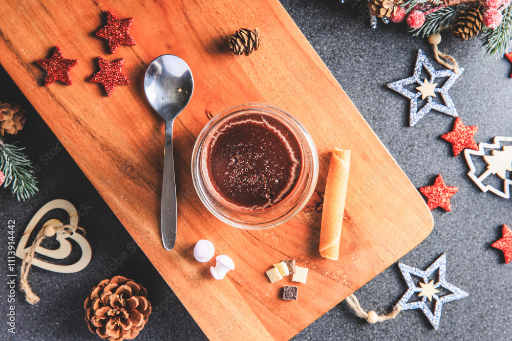Traditional hot chocolate with marshmallows and chocolate chips in a Christmas decoration