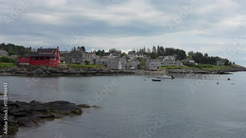 A panning view of the harbor at Monhegan Island of the northern coast of Maine on a cloudy day. photo