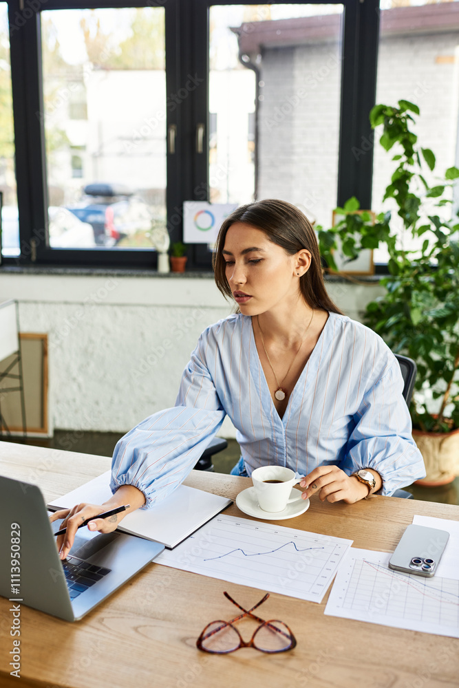 Bright and inviting workspace features a focused young woman sipping coffee while working. Bright and inviting workspace features a focused young woman sipping coffee while working.