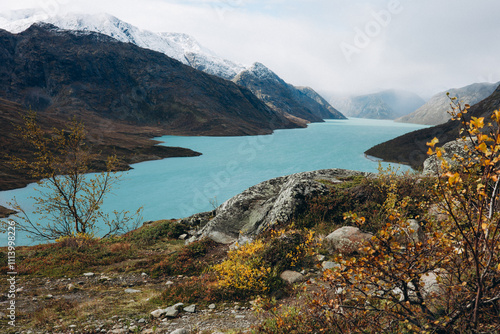 Turquoise Lake Surrounded by Snow-Capped Mountains in Gjendesheim, Norway photo