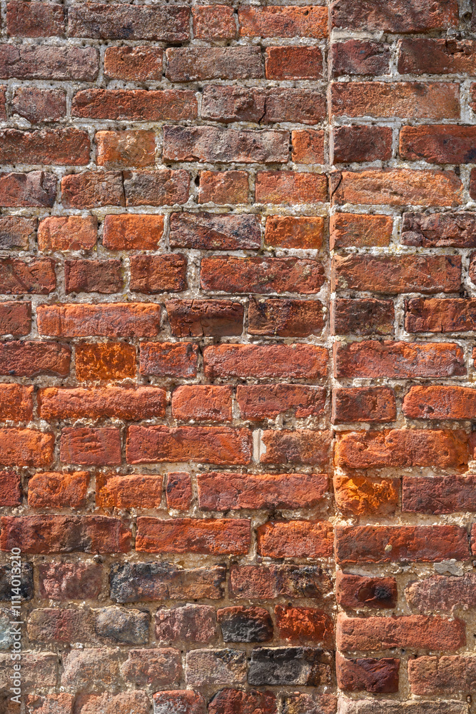 An old weathered, damaged, badly repaired red brick wall full frame An old weathered, damaged, badly repaired red brick wall full frame
