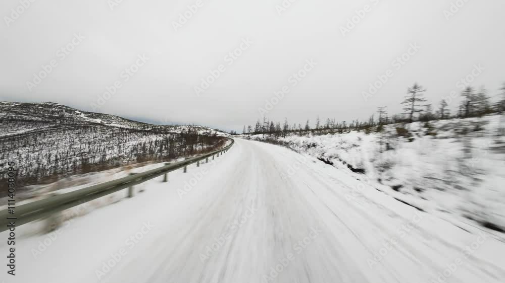 A tranquil winter scene featuring a snow-covered road stretching through a rural area. Overcast skies create a solemn atmosphere, enhancing the serene beauty of the landscape. A tranquil winter scene featuring a snow-covered road stretching through a rural area. Overcast skies create a solemn atmosphere, enhancing the serene beauty of the landscape.