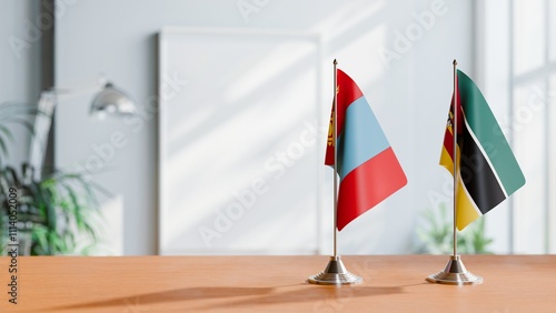 FLAGS OF MONGOLIA AND MOZAMBIQUE ON TABLE photo