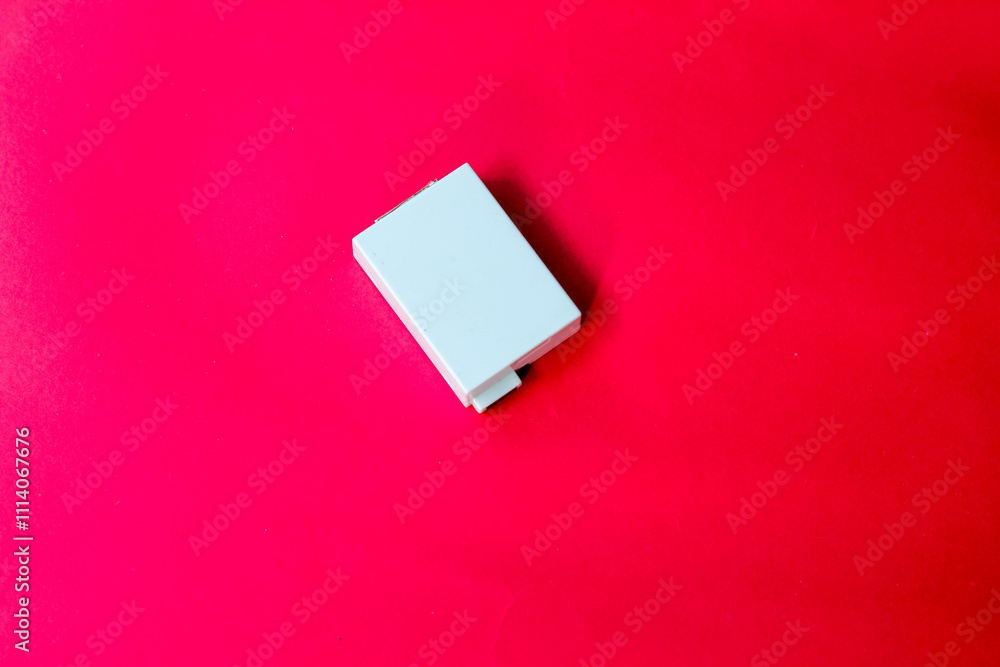 digital camera battery isolated red background digital camera battery isolated red background