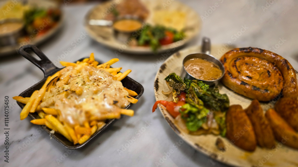 mouthwatering German worst curled up cumberland sausage meal featuring a grilled sausage, loaded cheese fries, and fresh vegetables served on a rustic plate mouthwatering German worst curled up cumberland sausage meal featuring a grilled sausage, loaded cheese fries, and fresh vegetables served on a rustic plate