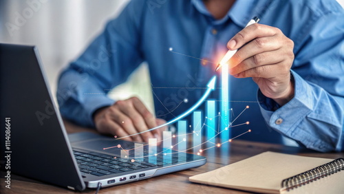Person pointing at a glowing growth chart on a laptop, showcasing business success and upward trends.