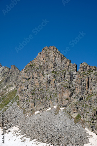 Towering Rocky Peak with Snow-Covered Cliffs