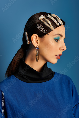 A young woman confidently poses in stylish attire, complete with chic hair clips. photo