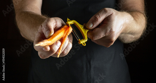 Bright orange carrots are held firmly as hands expertly peel their skin away, showcasing culinary skill in a warm, intimate kitchen setting filled with creativity and passion for cooking photo