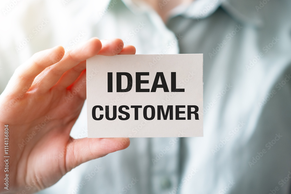 Ideal Customer text on business card in hand. Business concept Ideal Customer text on business card in hand. Business concept
