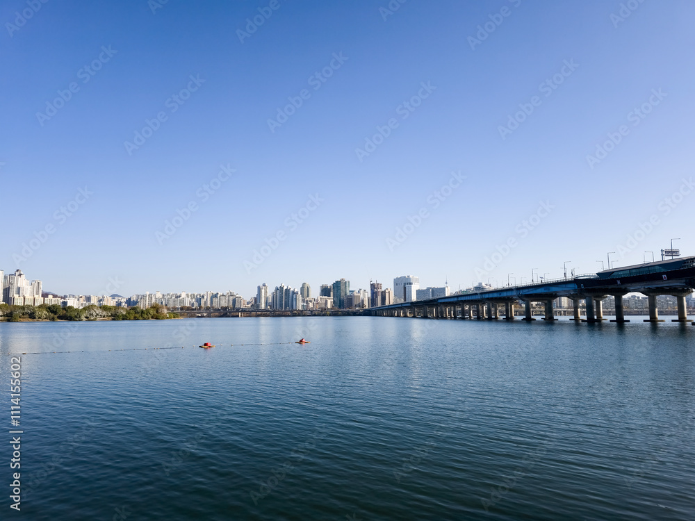 panorama view of the river, Yeouido Hangang River Park, in Seoul, Korea, with a broad bridge, and a cityscape in the backdrop
panorama view of the river, Yeouido Hangang River Park, in Seoul, Korea, with a broad bridge, and a cityscape in the backdrop