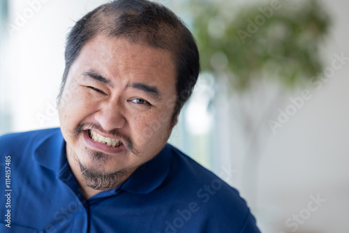 Bilde på lerret Frustrated and disappointed Asian middle aged man with negative facial expressio
