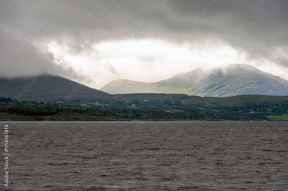 A cloudy day with a mountain in the background A cloudy day with a mountain in the background