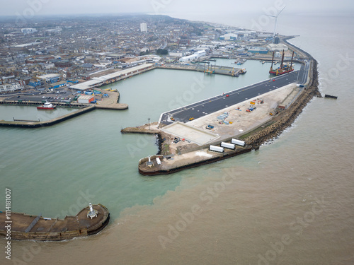 Aerial view of the commercial port of Lowestoft on the Suffolk, UK coastline. The large harbour area and multiple docking facilities can be seen. A platform is used for access to large, commercial ves photo