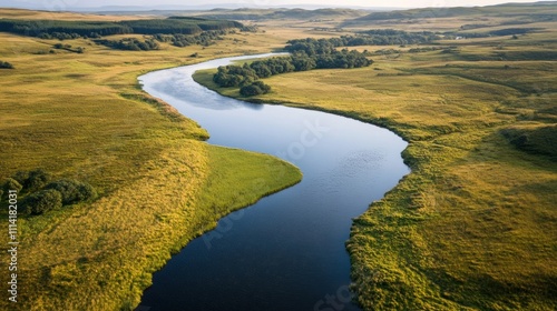 Aerial view of a river meeting a tranquil lake at one end