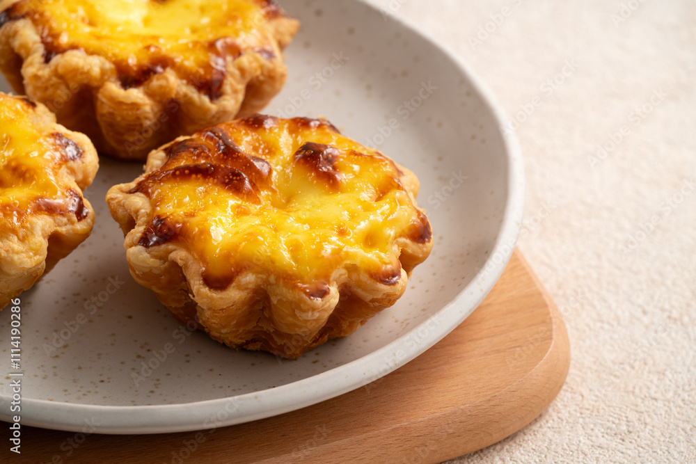 Delicious puff pastry Portuguese egg tart Pastel de nata in flower shape. Delicious puff pastry Portuguese egg tart Pastel de nata in flower shape.