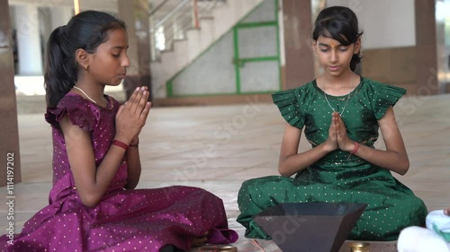 A Hindu family gathered around a sacred fire, performing a Yagya or havan