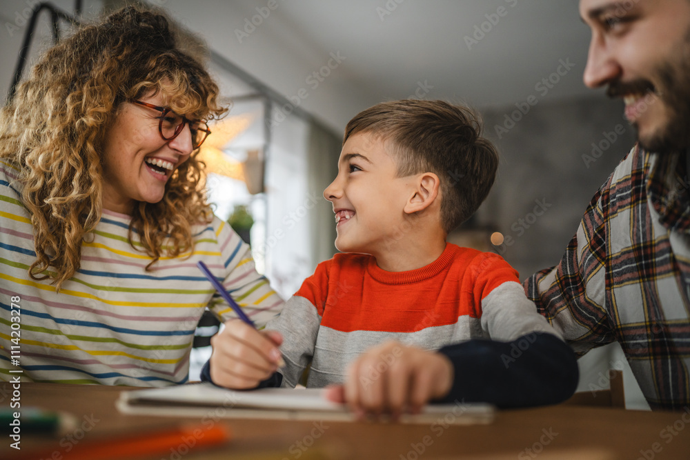 Fototapeta premium Mum and dad help their son to draw, enjoy creative hobby at home