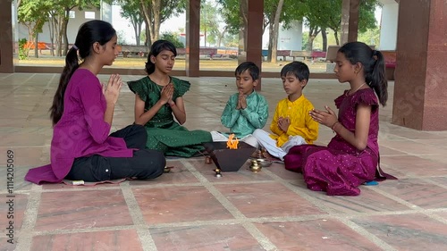 A Hindu family gathered around a sacred fire, performing a Yagya or havan