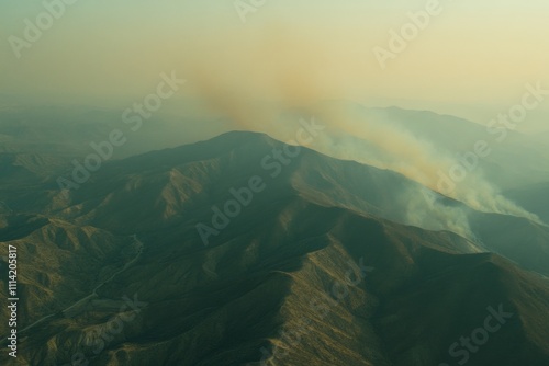 Wildfire action spreading across mountain range aerial view nature environment evocative imagery of destruction photo