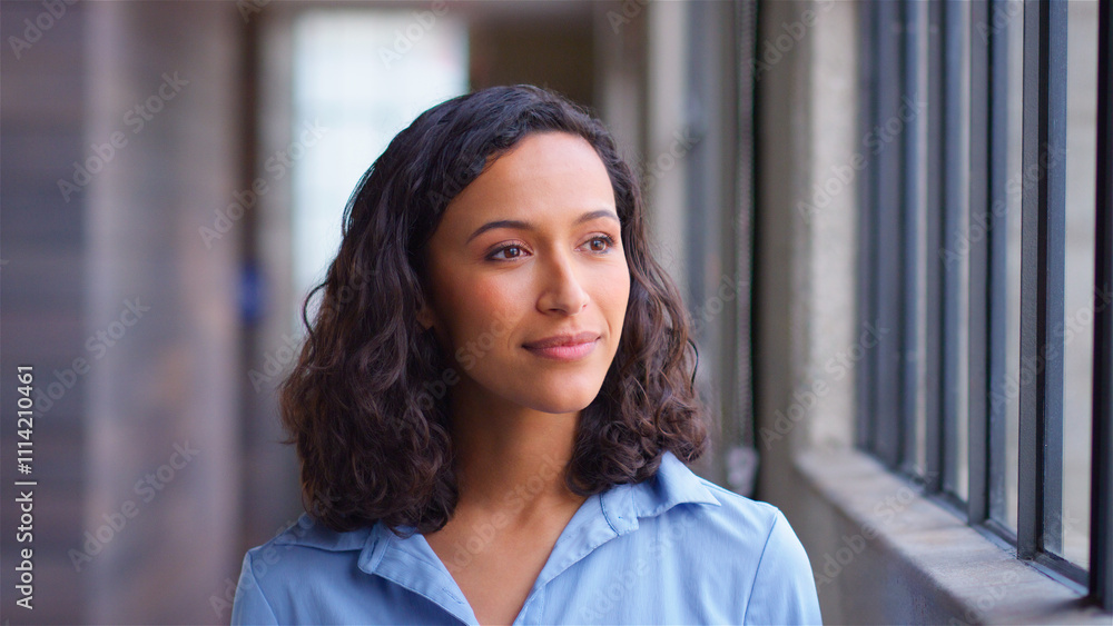Head And Shoulders Portrait Of Confident Businesswoman Standing By Window In Modern Office Head And Shoulders Portrait Of Confident Businesswoman Standing By Window In Modern Office