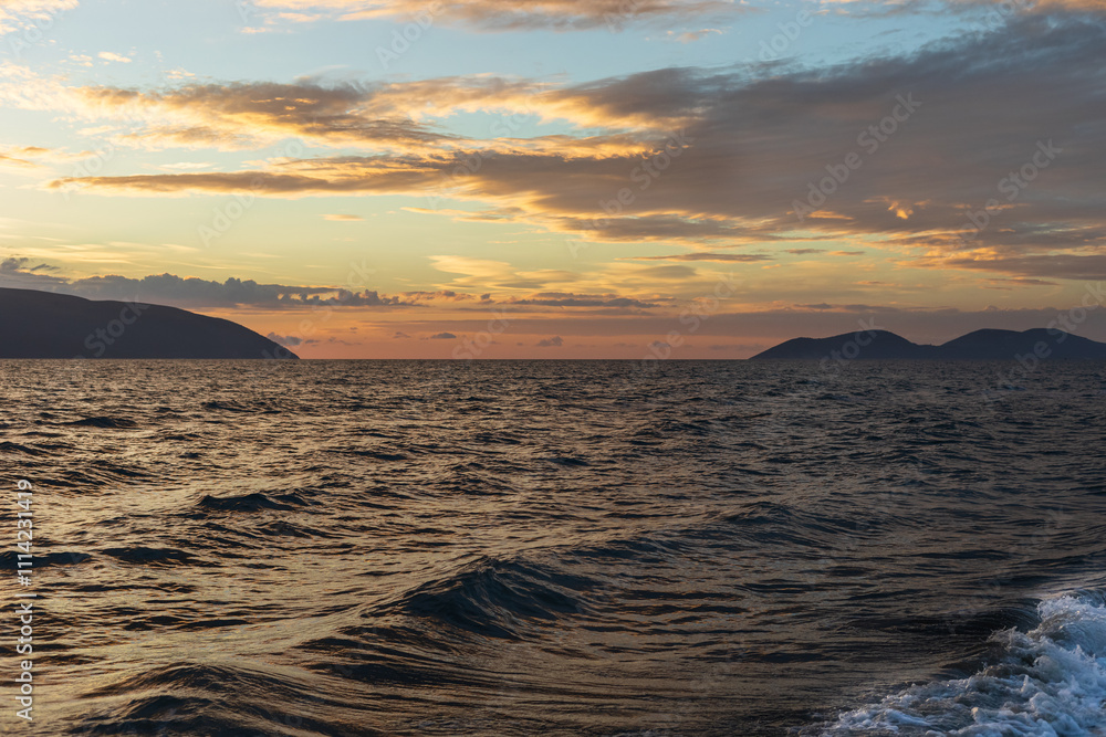 Φωτογραφία Sunset, Sky clouds over sea in the Evening with Orange, Yellow Gold sunlight at Golden hour