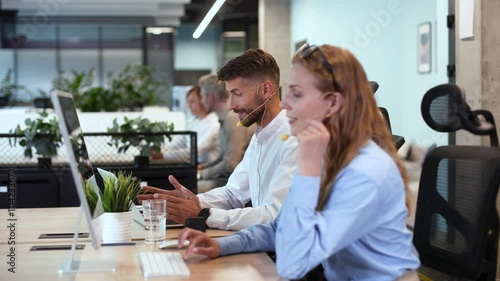 Man and colleagues in a call center office for customer service help and support