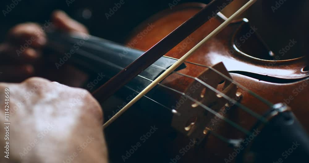 Super slow motion close up of master luthiers hands draw bow across strings of handmade violin at 1000 fps.Each movement showcase precision and artistry in both playing and craftsmanship of instrument Super slow motion close up of master luthiers hands draw bow across strings of handmade violin at 1000 fps.Each movement showcase precision and artistry in both playing and craftsmanship of instrument