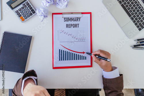 annual performance graph is in downtrend due to impact of the global economic slowdown and international wars. annual performance graph in downtrend is placed on table in front of businessman. photo