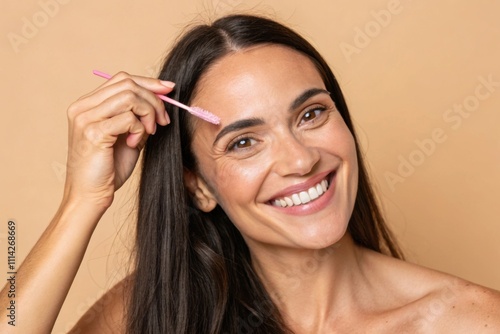 Smiling Woman Combing Brows With Pink Brush On Beige Background