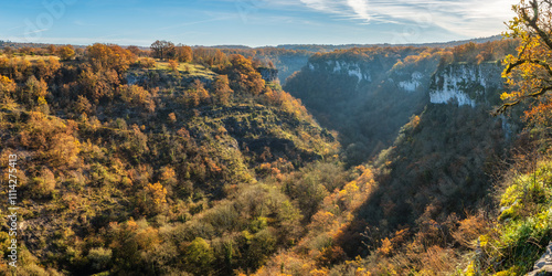 Steep sided tree lined canyon plunging down to the Alzou river near Gramat in the Lot region of France