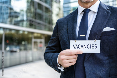 Corporate professional in tailored suit holding crisp 