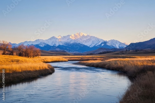 Serene River Flows Past Autumnal Grasslands Towards Snowy Mountains