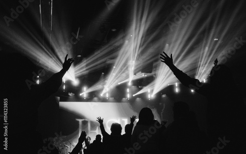 people raising their hands in worship at church photo