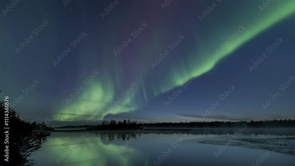 Auroras starting to dance at dusk above a still lake Auroras starting to dance at dusk above a still lake