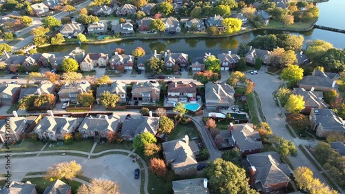 Quiet cul-de-sac dead-end keyhole shape street in upscale lakeside neighborhood water fountain in Coppell, suburbs Dallas, Texas, large single-family houses swimming pools, autumn leaves, flyover